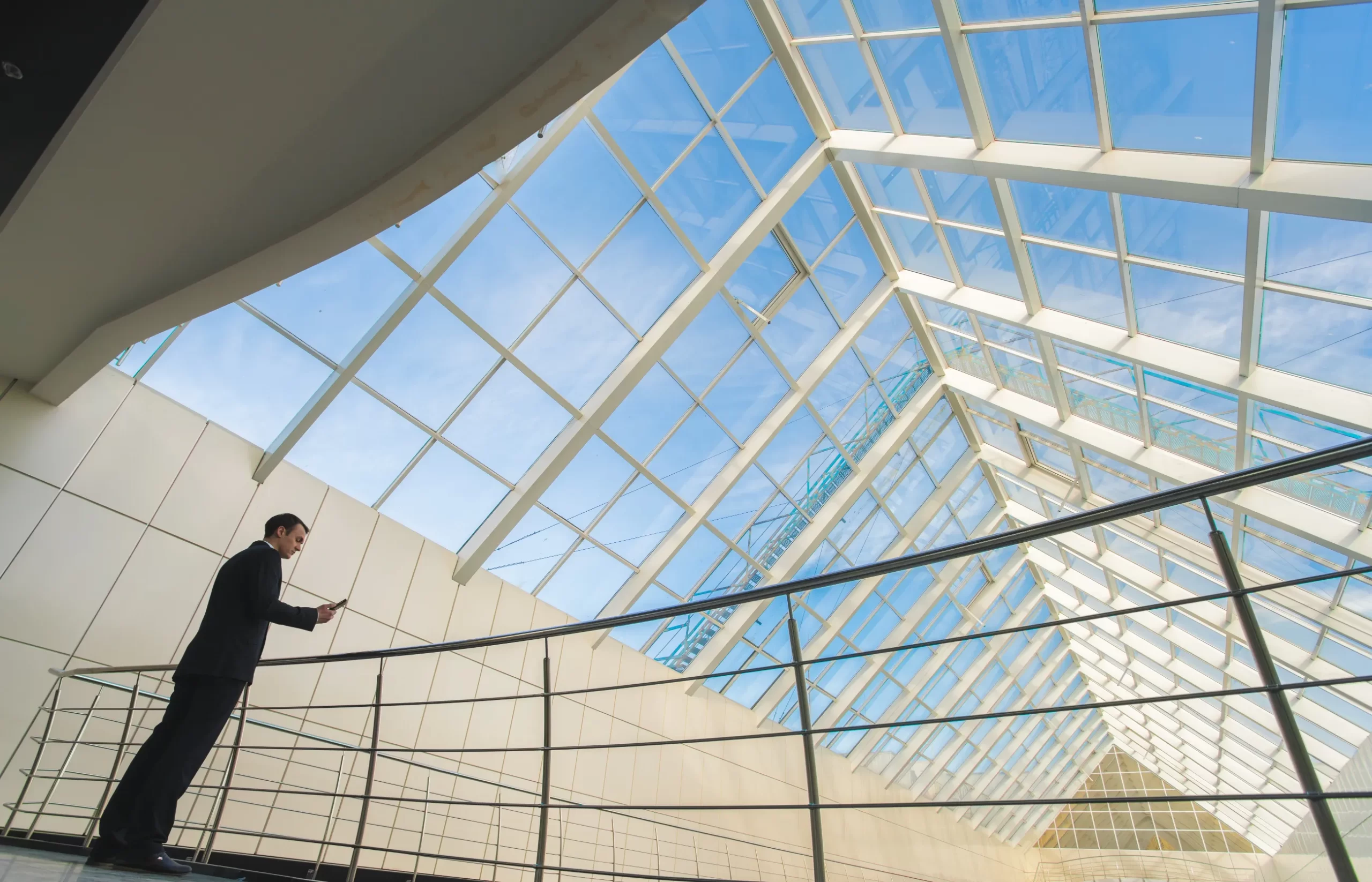 man-stand-office-balcony-phone