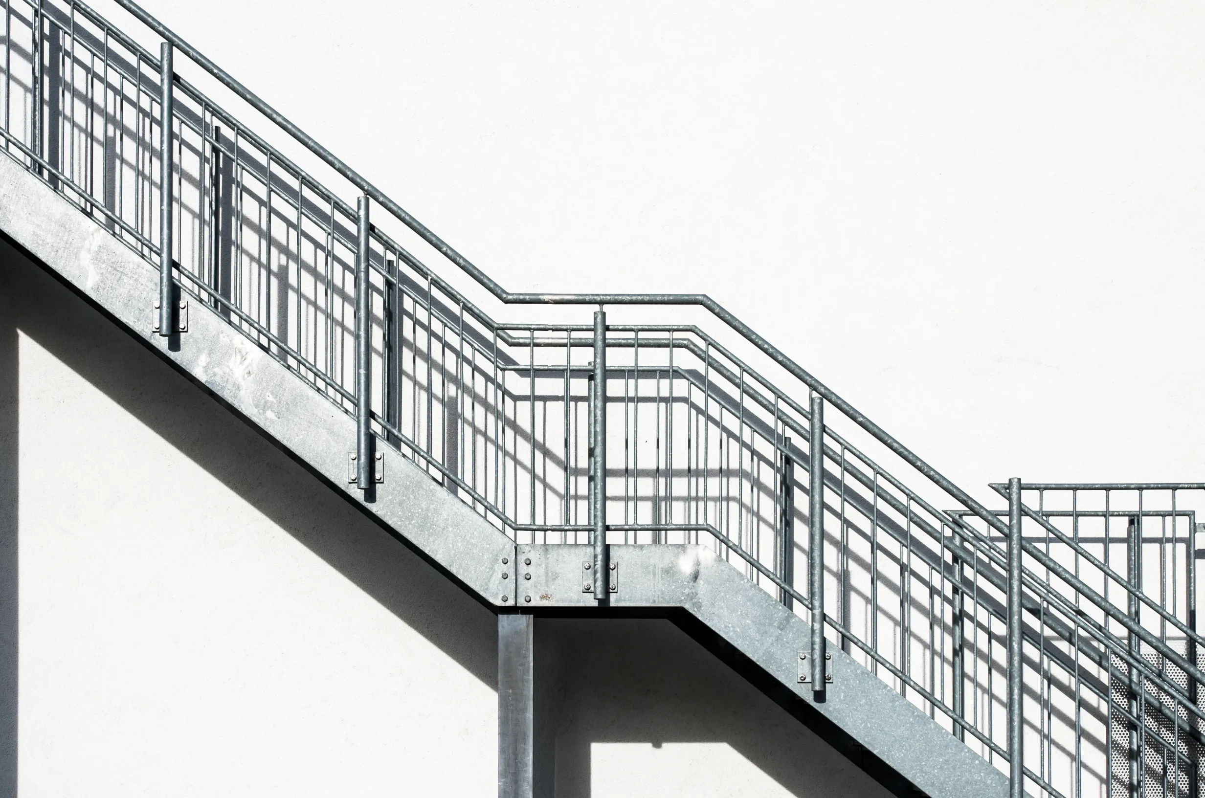 metal-stairs-white-building-wall