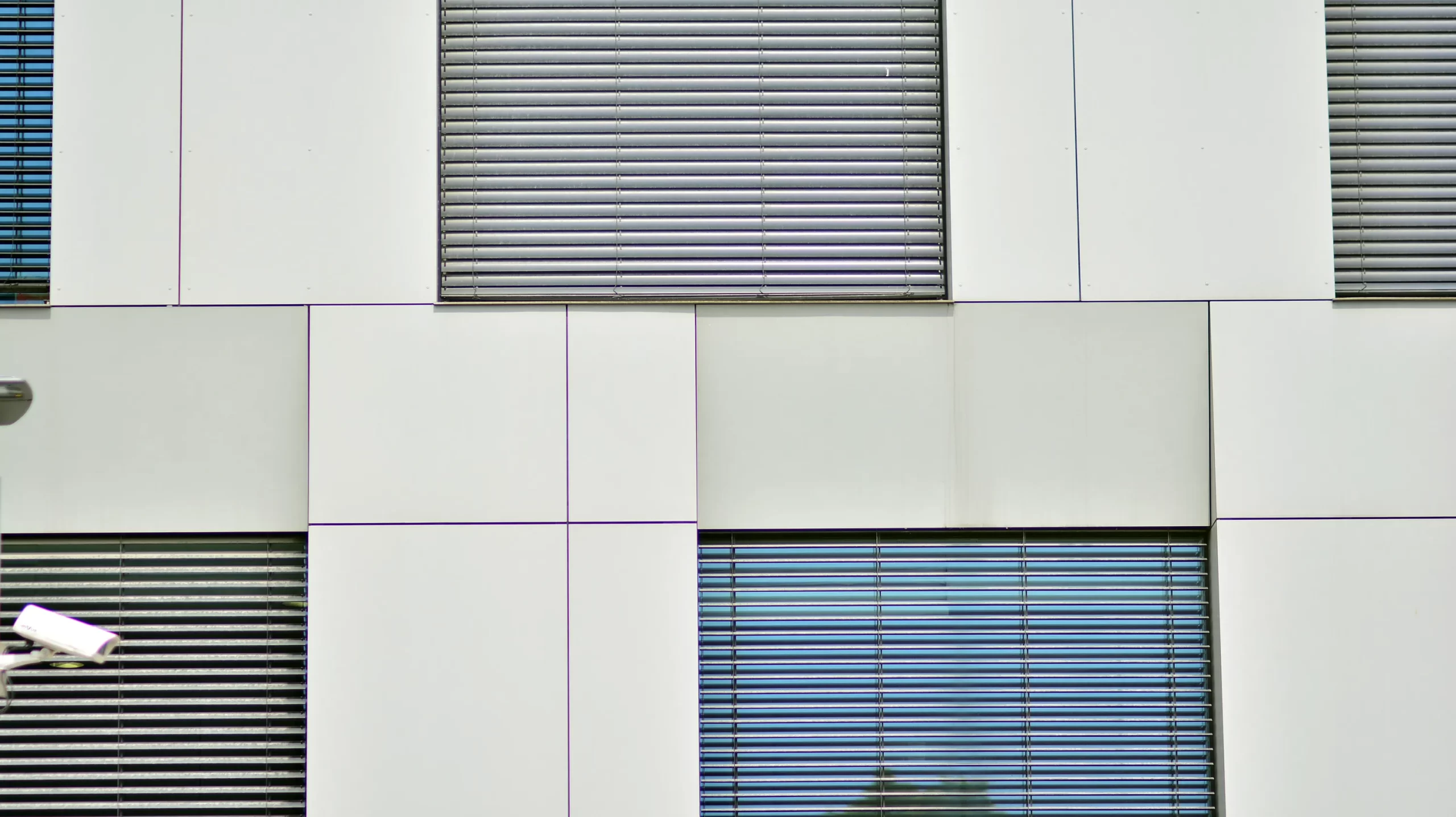 white-tile-wall-with-window-that-has-reflection-tree-it